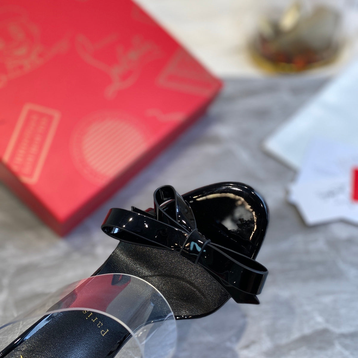 Black high-heeled mules with butterfly-shaped transparent detail; 10cm heel.