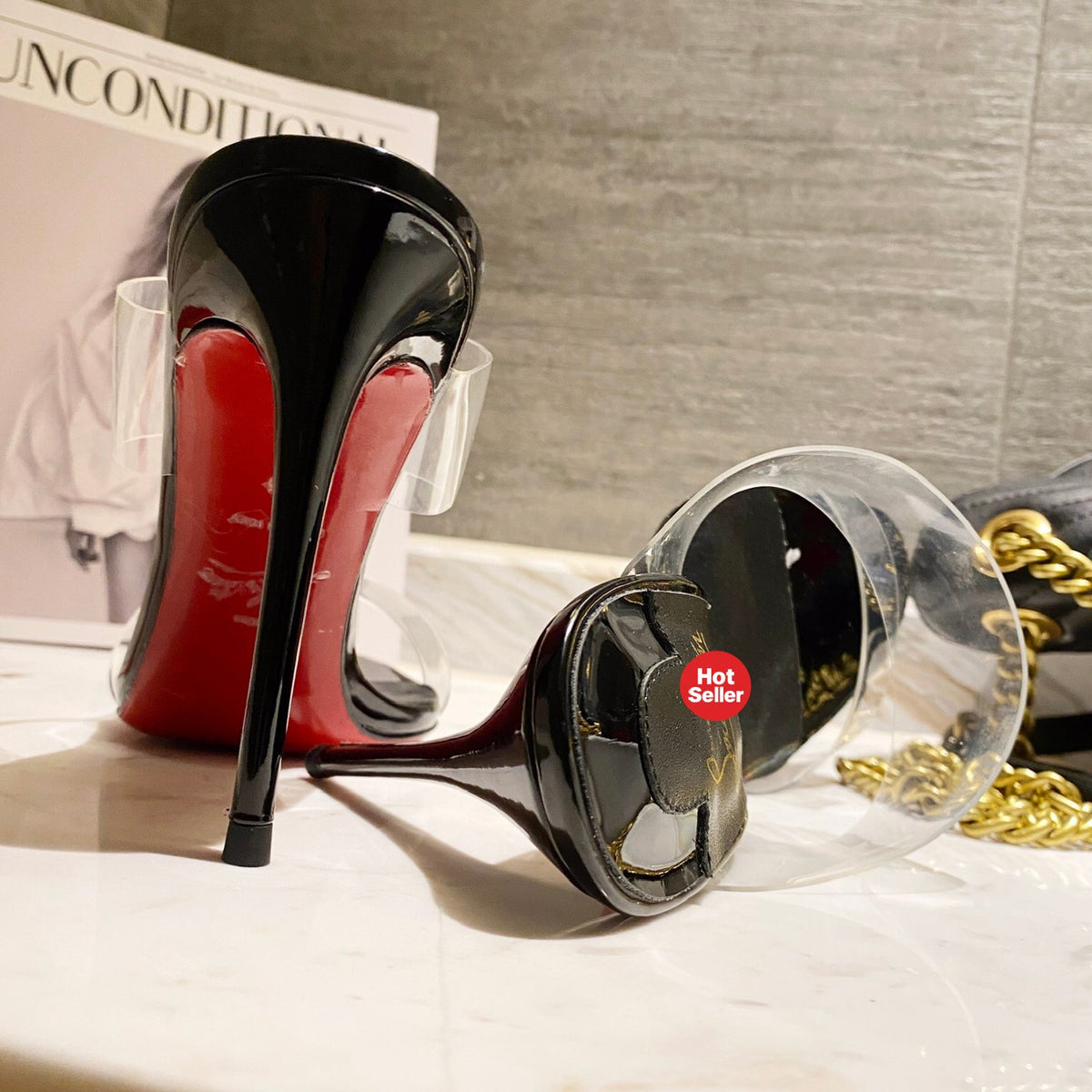 Black high-heeled mules with transparent detailing; 10cm heel.