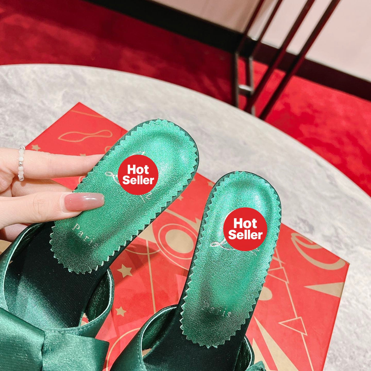 Green high-heeled mules with butterfly-style detail; heel height: 8.5 cm.