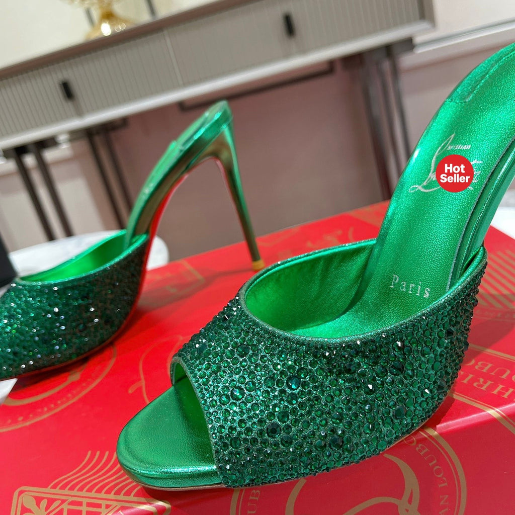 Green peep-toe high-heeled mules with rhinestone embellishment; 10cm heel.