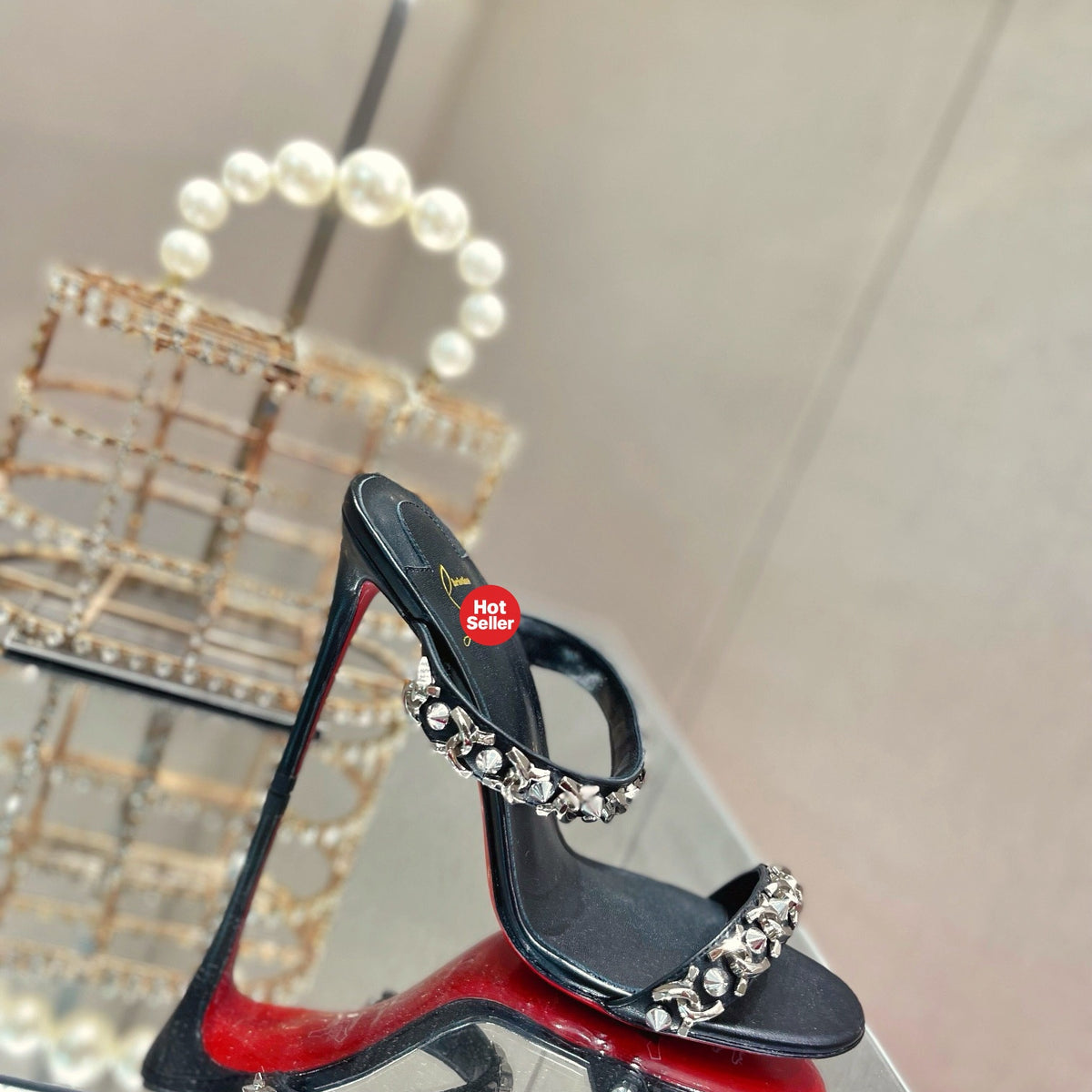 Chain-detail high-heeled mules, 10cm heel.