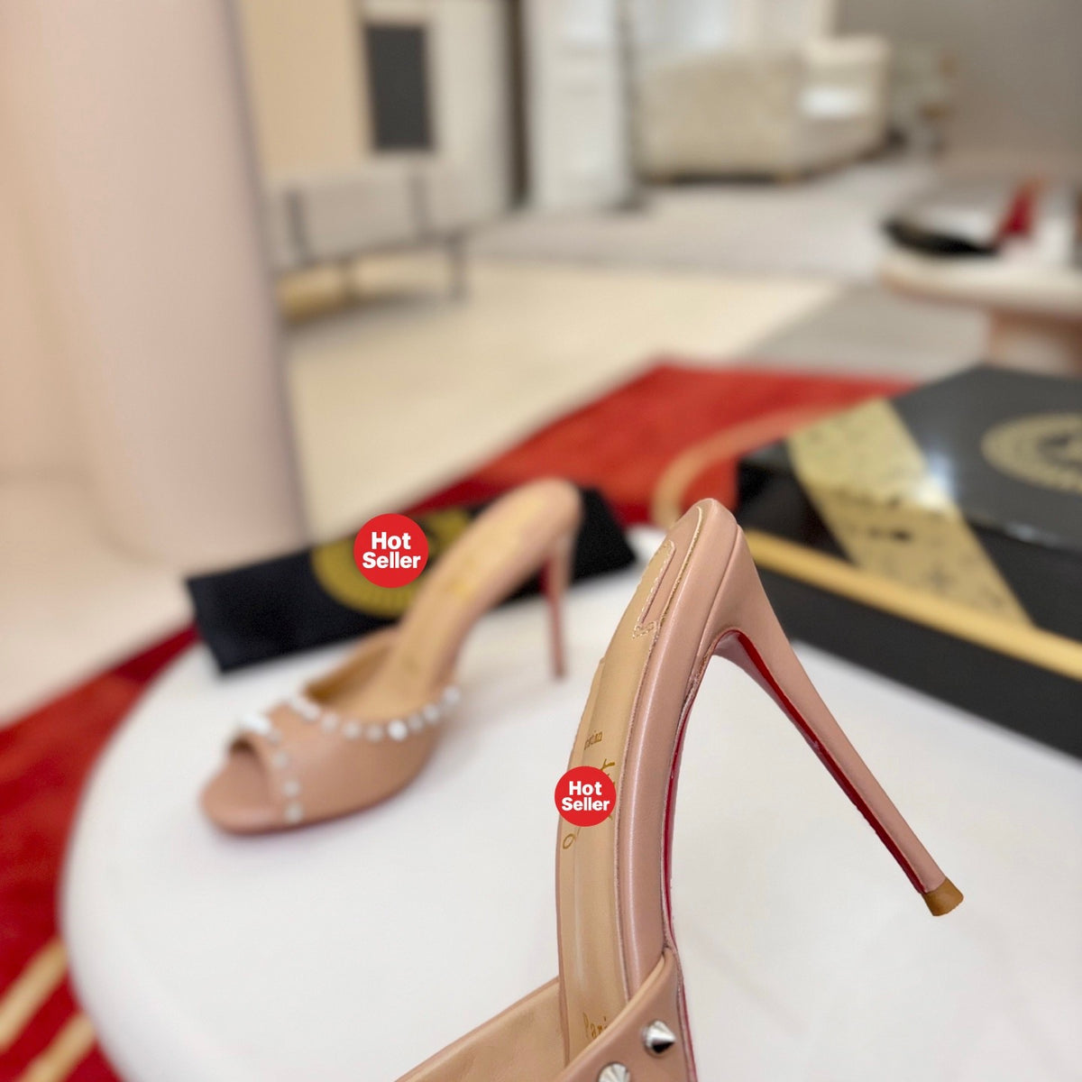 Apricot peep-toe high-heeled mules with stud detailing; 8.5cm heel.