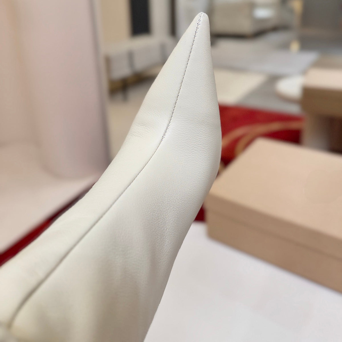 The boot's tapered silhouette creates a refined, modern look. This style features a 100mm stiletto heel.