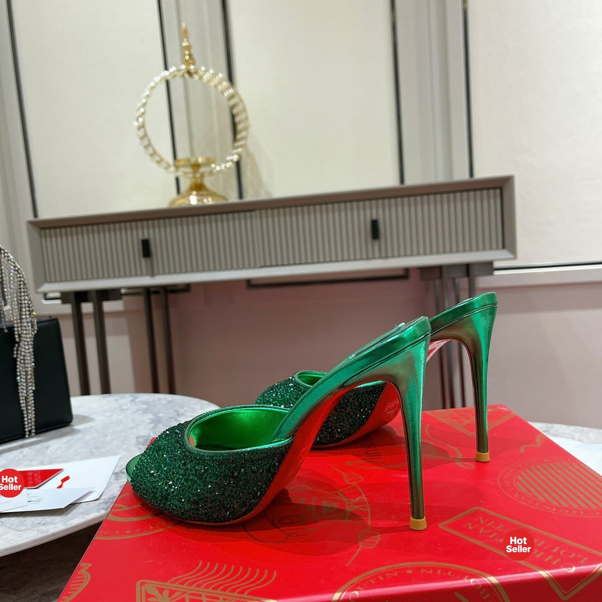 Green peep-toe high-heeled mules with rhinestone embellishment; 10cm heel.