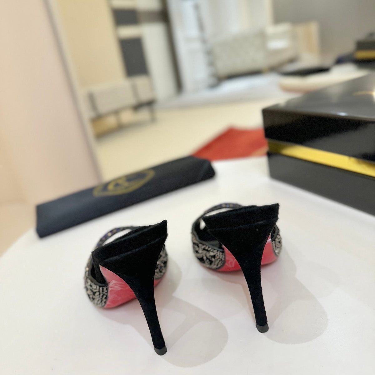 Black cutout high-heeled mules with all-over pavé crystals; 10cm heel.