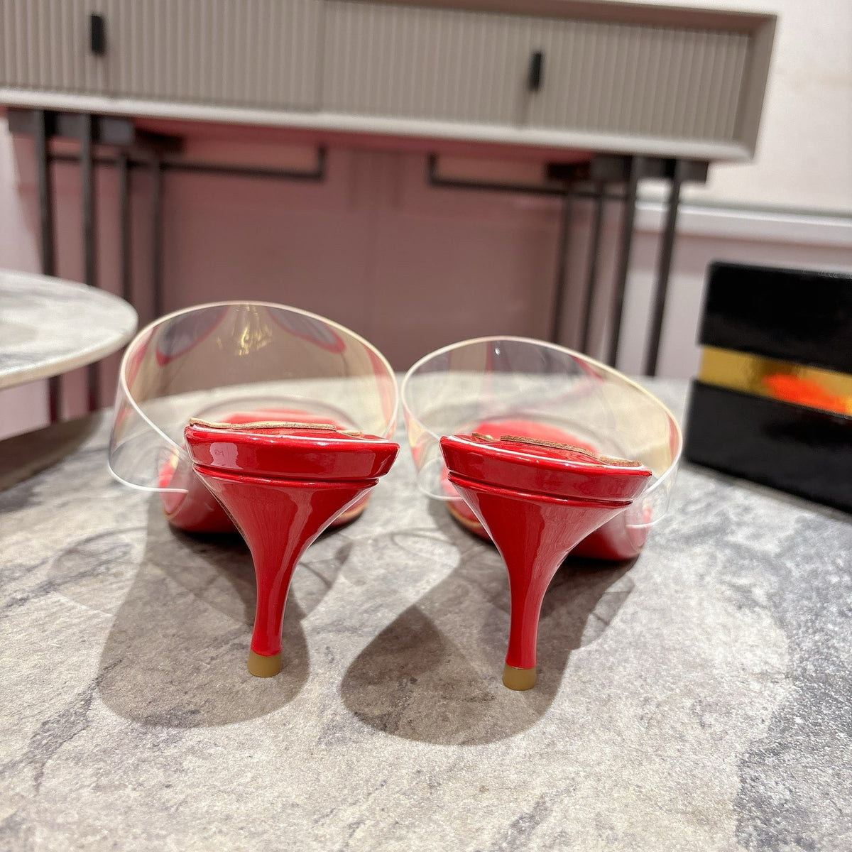Red translucent high-heeled mules, 8.5cm heel.
