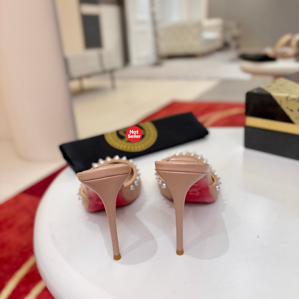 Apricot peep-toe high-heeled mules with stud detailing; 8.5cm heel.
