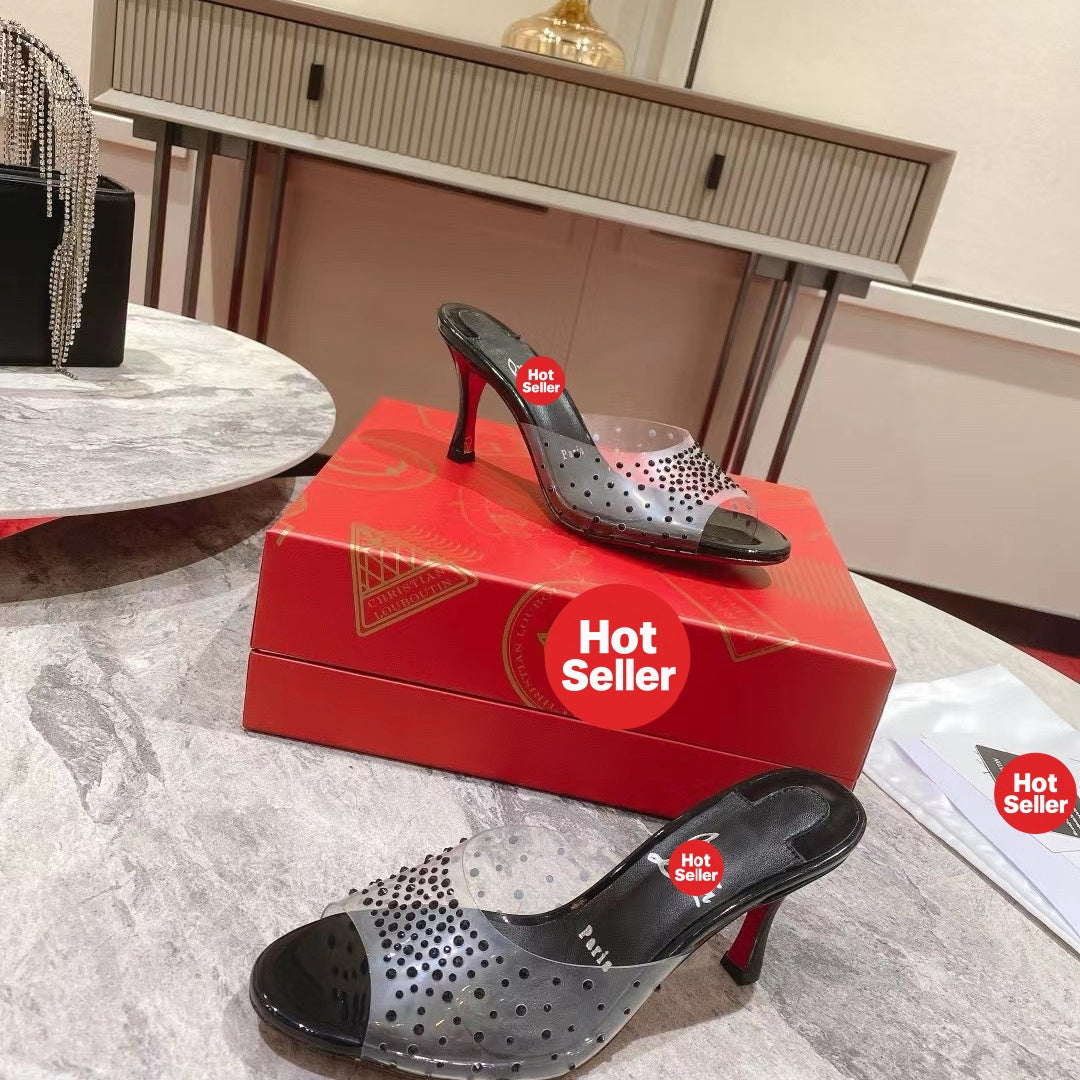 Black open-toe high-heeled mules with transparent strap detail; 8cm heel.