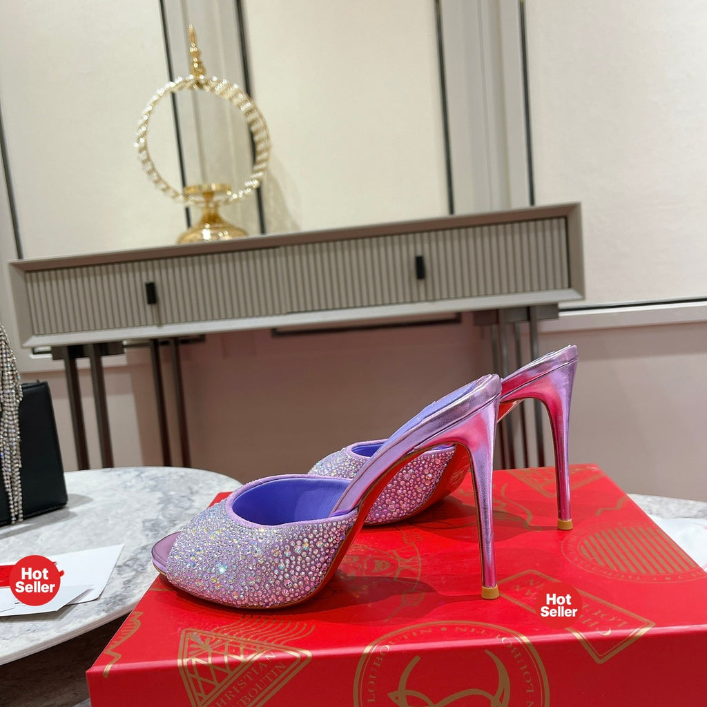 Purple peep-toe high-heeled mules with rhinestone embellishment; 10cm heel.