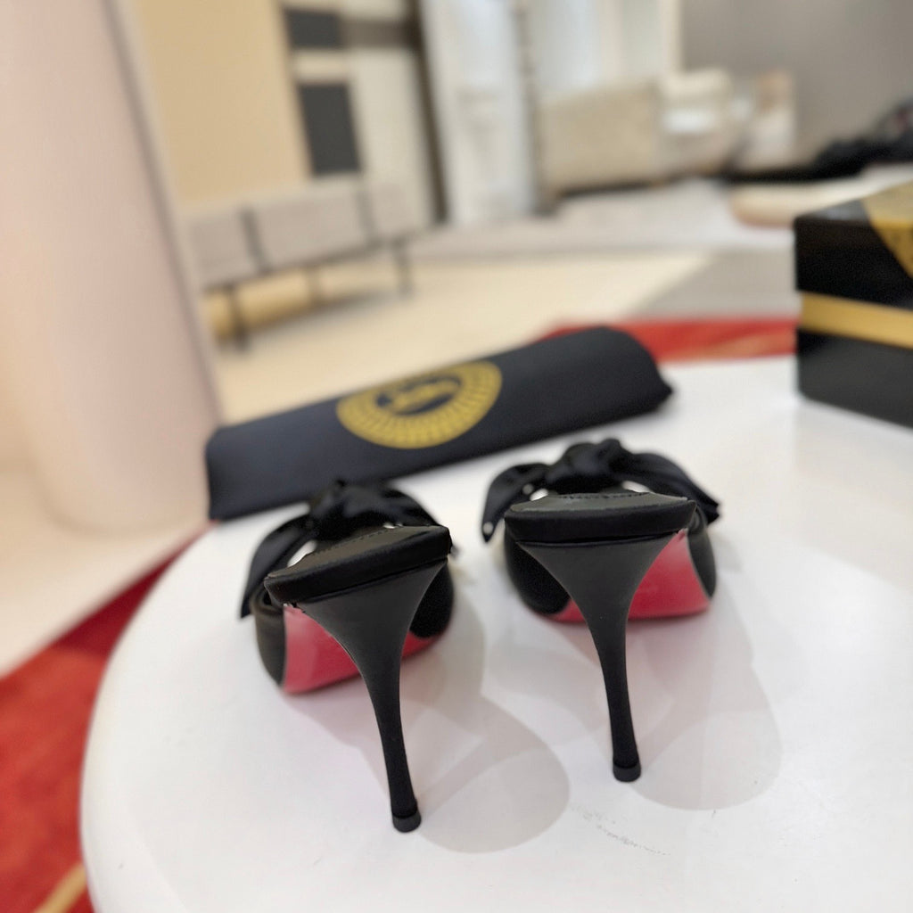 Black bow-detail high-heeled mules, 10cm heel.