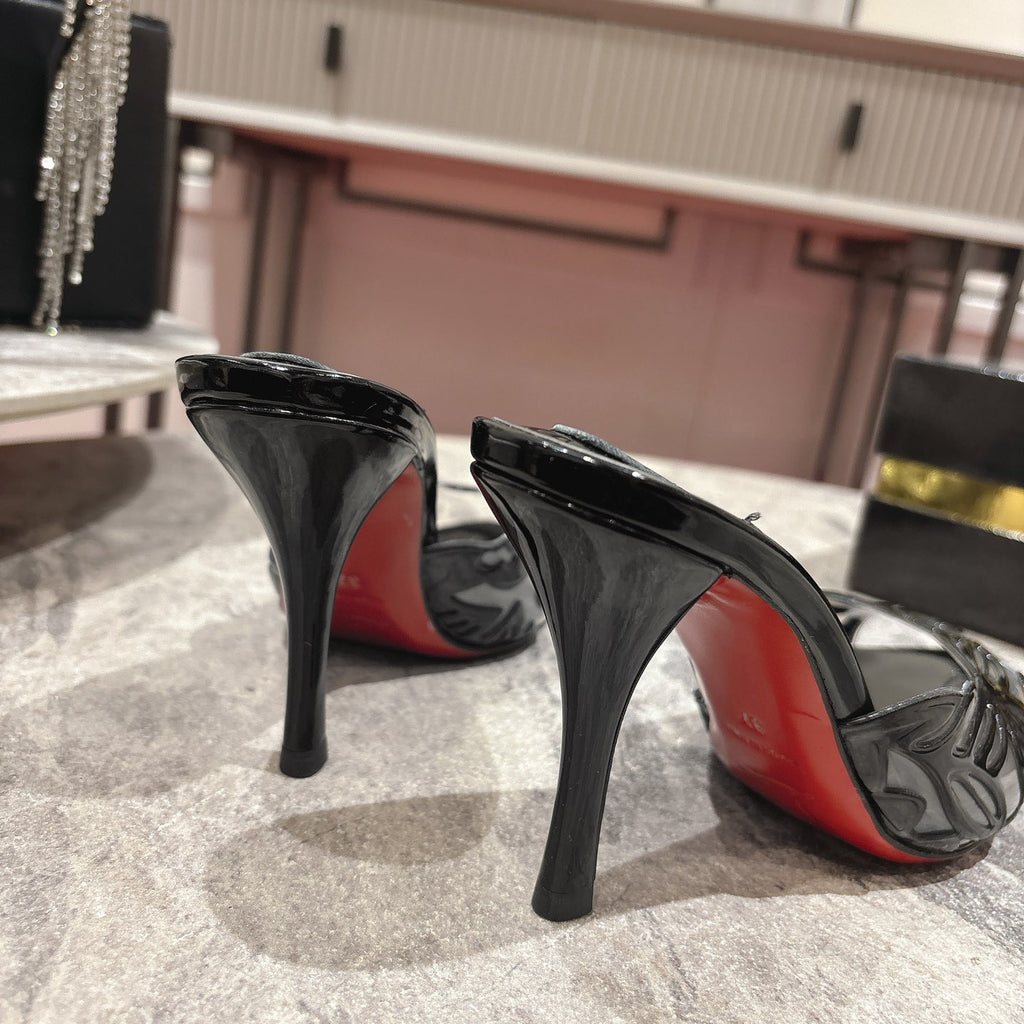 Black high-heeled mules with a stylish cutout design; 10cm heel.